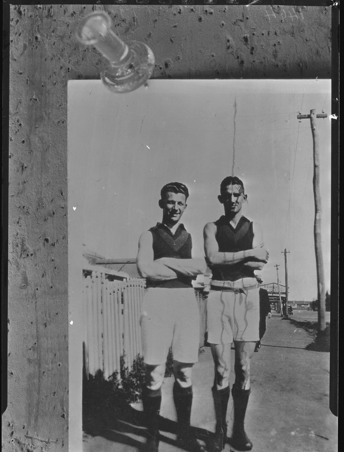 097935PD Copy of a snapshot of two footballers standing in a Merredin street copy made in Kalgoorlie