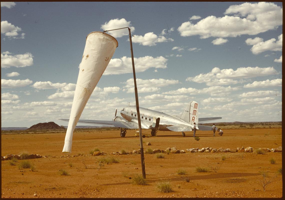Windsock and MMA DC3 VH-MMM RMA Murchison on the airstrip at Roy Hill Station 1962