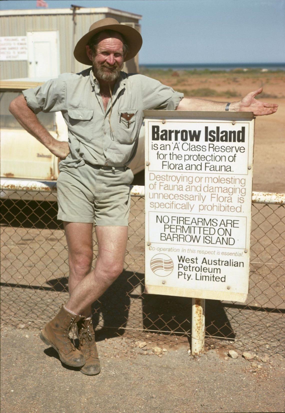 Harry Butler at a sign proclaiming Barrow Island as a A class nature reserve 1979