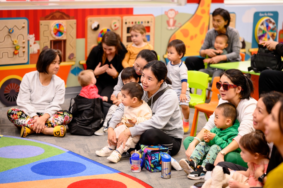 Parents and children listening to Story Time