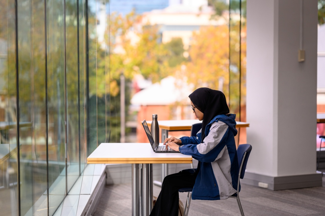 Person studying at the windows on Level 1