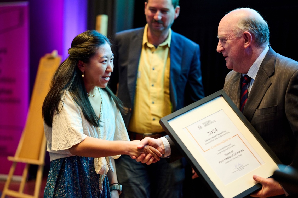 Ivy Chen Zhang and David Synder accepting a Commendation from Hon John Day