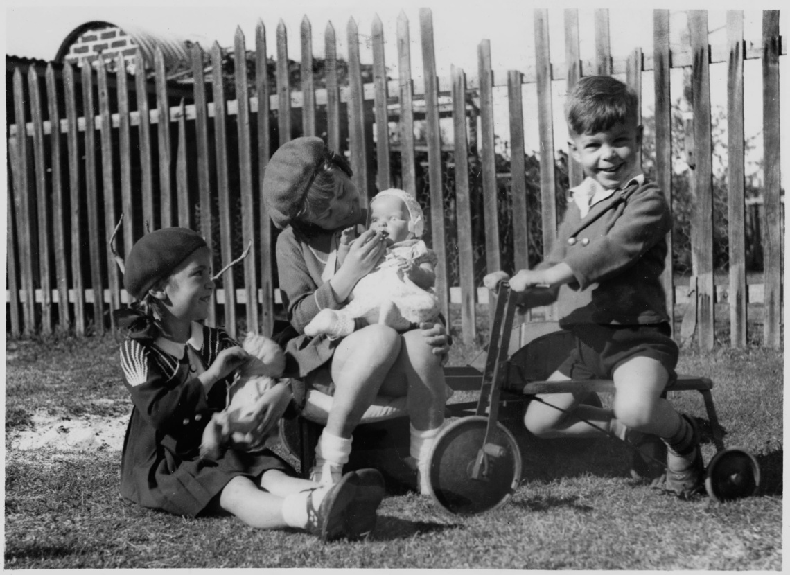 Jacqueline and Trevor Mallett with a friend playing in the garden 1937