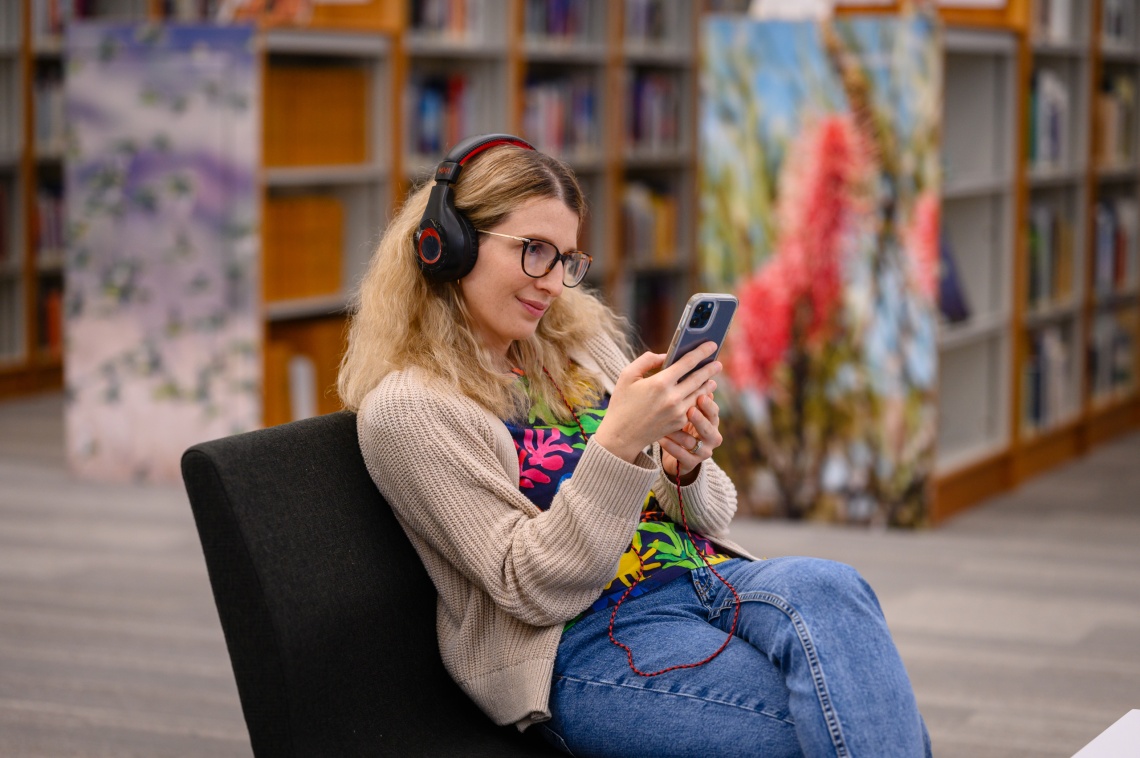 Women listening to music on headphones with a smart device