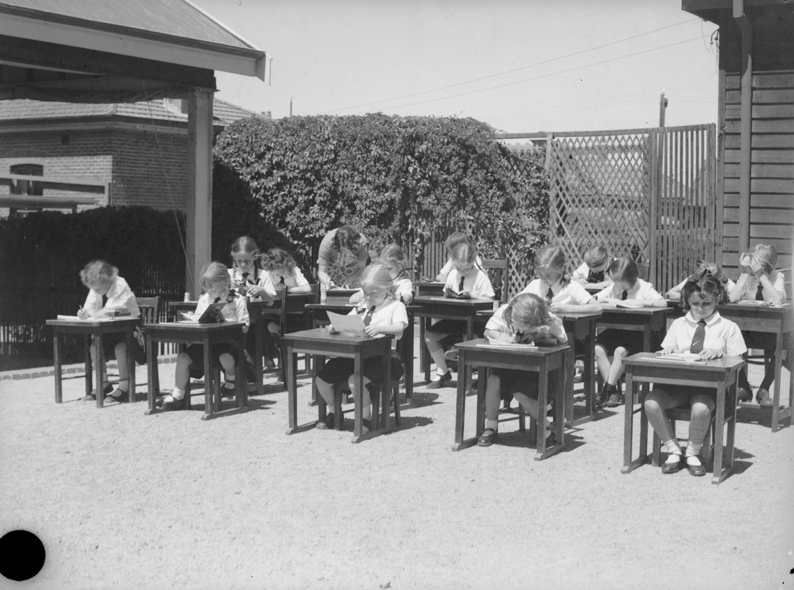 Children at their desks in the grounds of Perth College Mt Lawley 26 February 1941