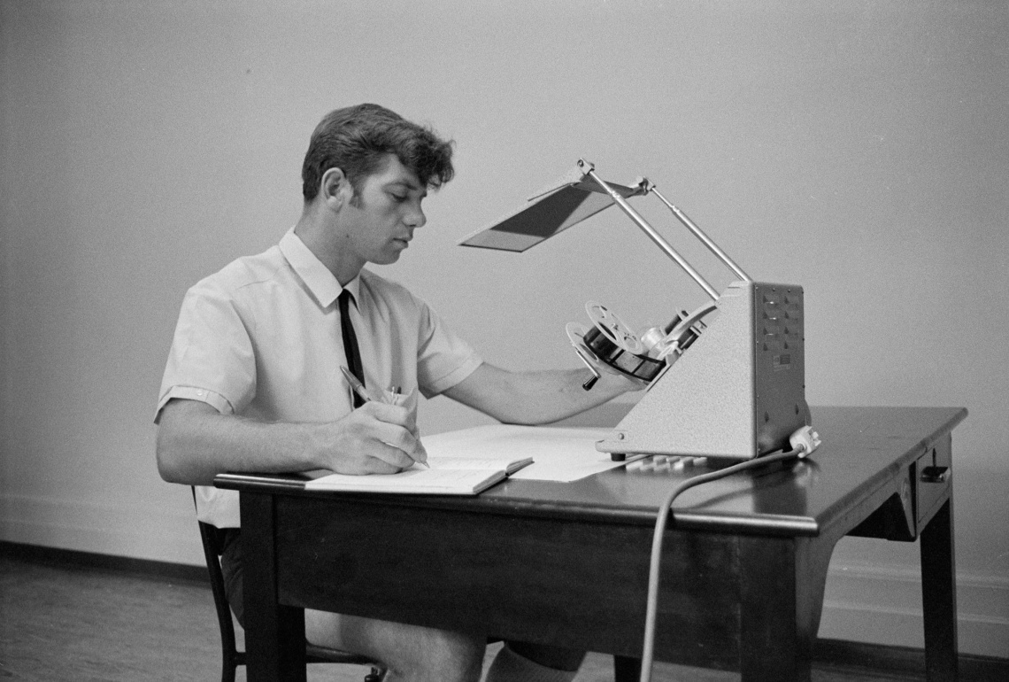 Person checking microfilm for quality and completeness JS Battye Library of West Australian History and State Archives 1969