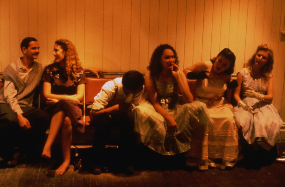 six people sitting on a bench