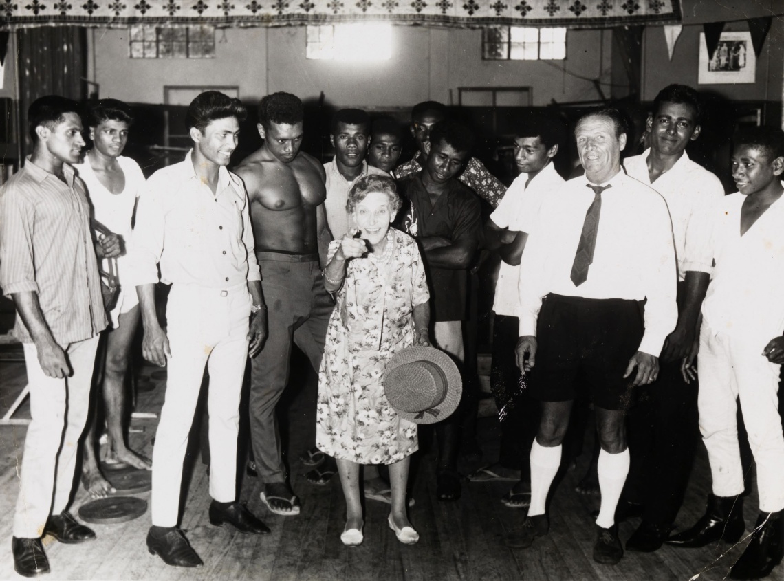 Effie Fellows in a gymnasium in Suva Fiji surrounded by young boxers and onlookers 1968
