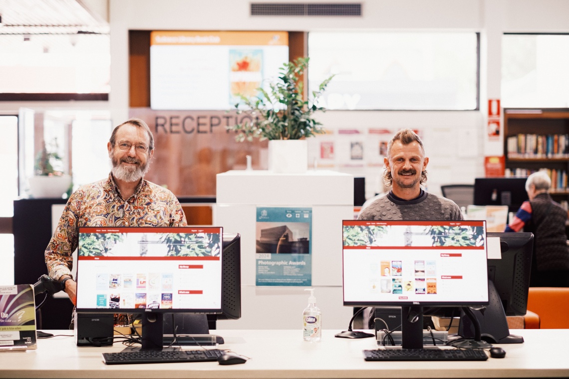 two men standing behind computers at Subiaco Library