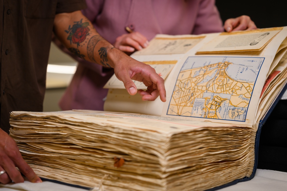 Looking at a book in the Leah Jane Cohen Reading Room 