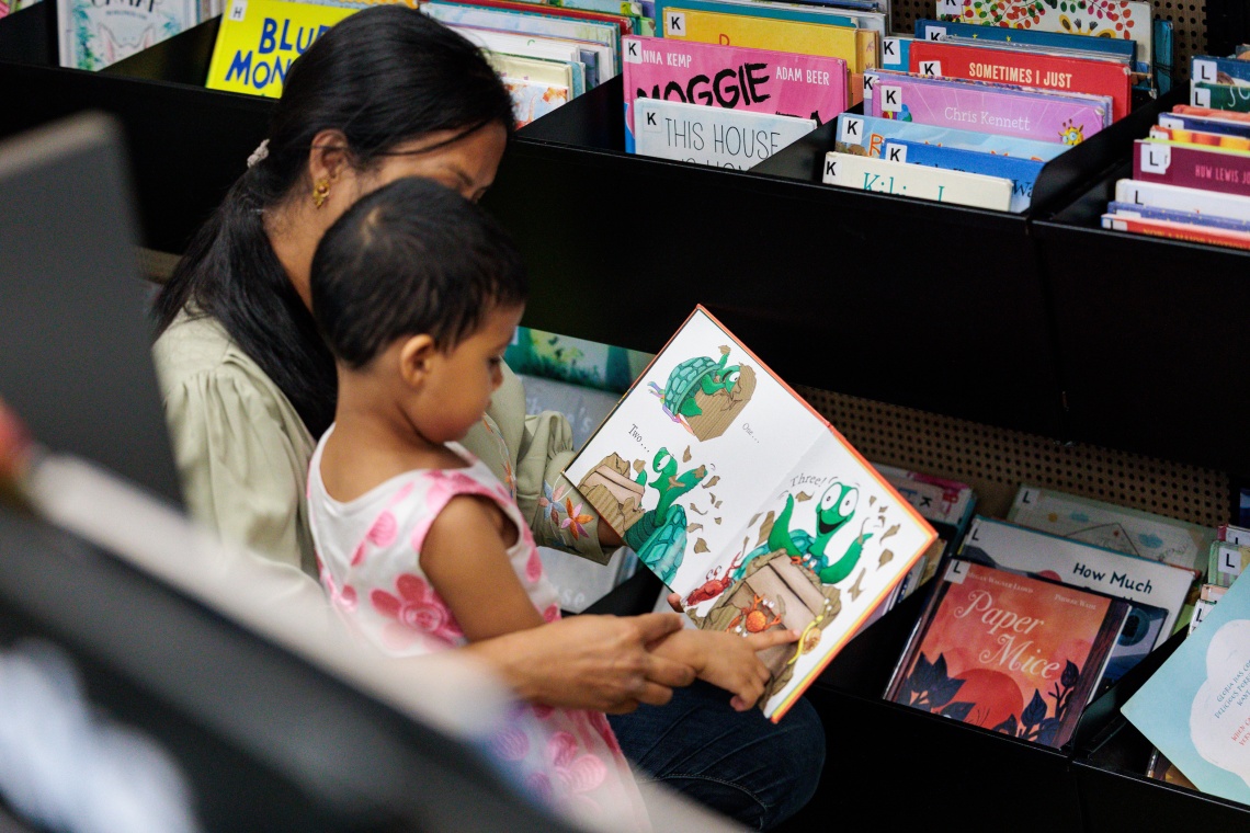 Mother and child looking at  book at the Ruth Faulkner Library in Belmont 2026