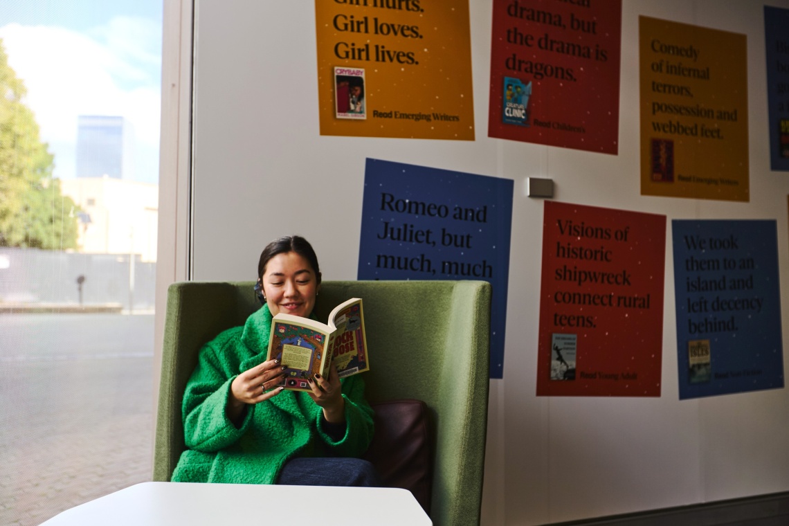 Wowan reading book by window