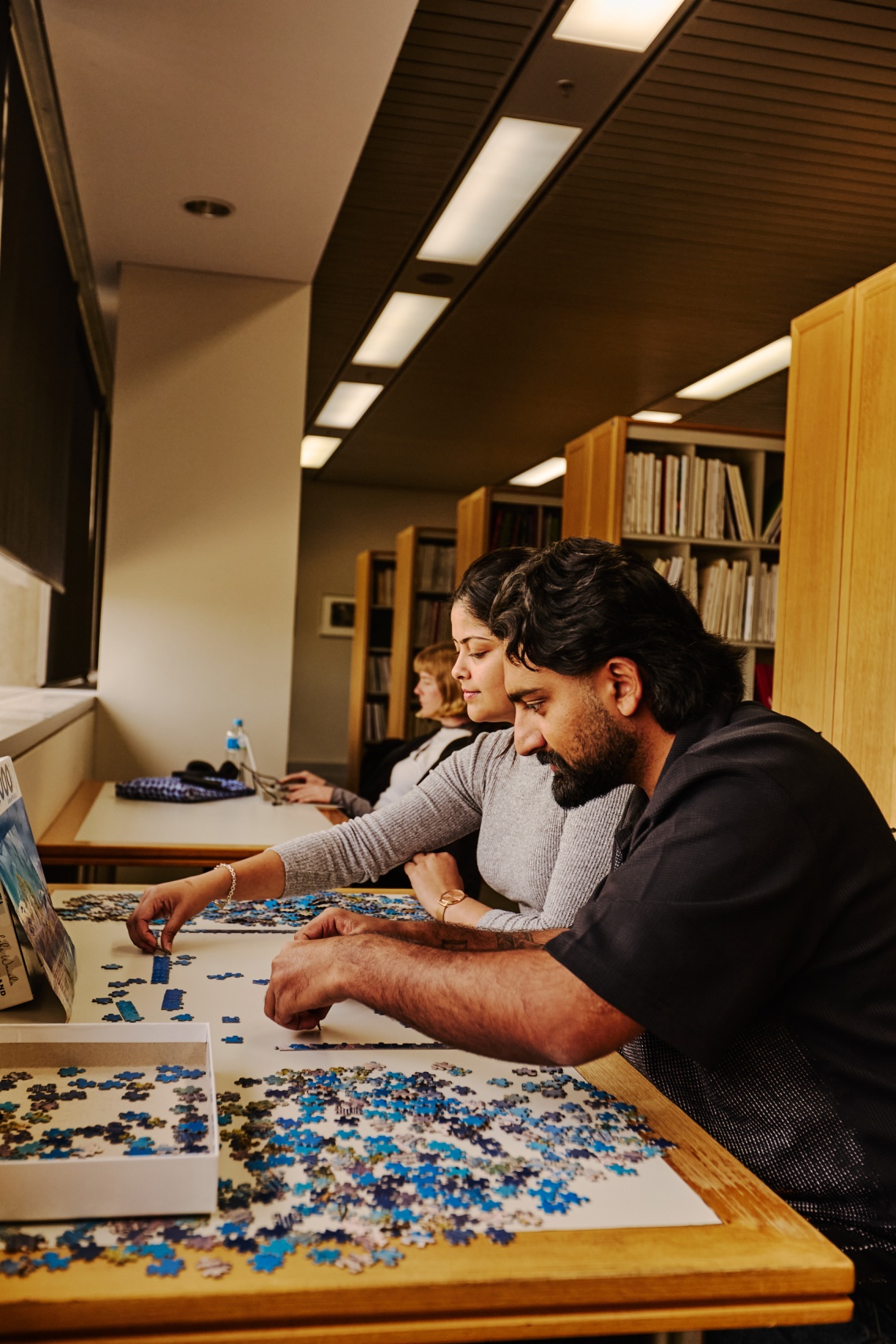 People playing with Jigsaw Puzzles