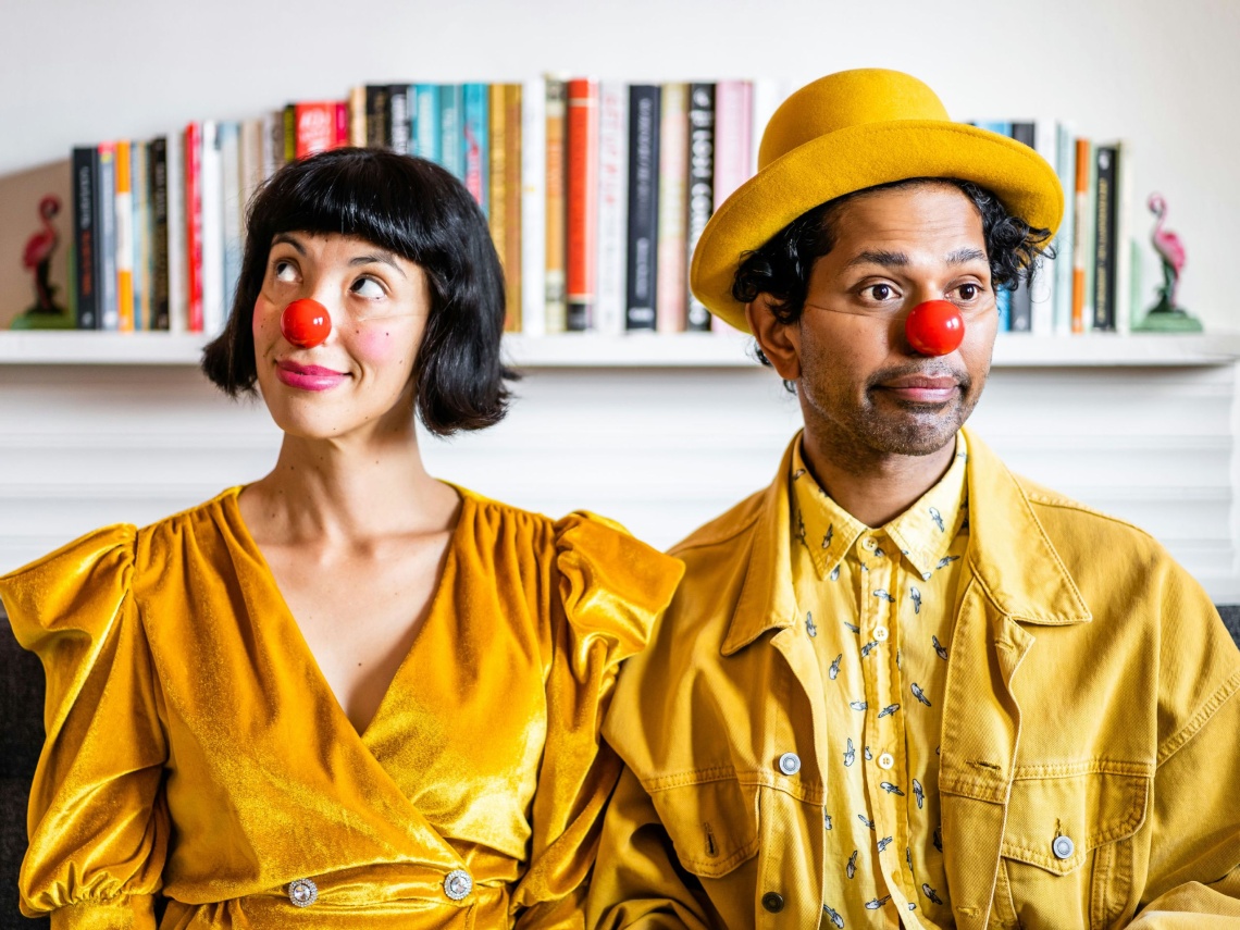 two dressed in yellow with red clown noses