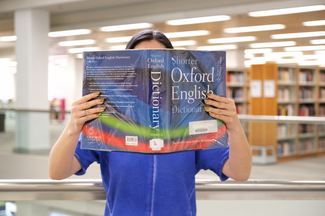 Woman reading Shorter Oxford English Dictionary