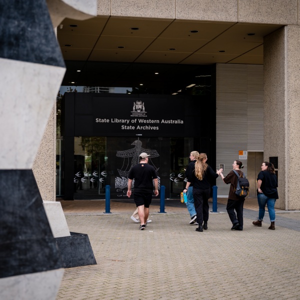 group of people walking into the State Library