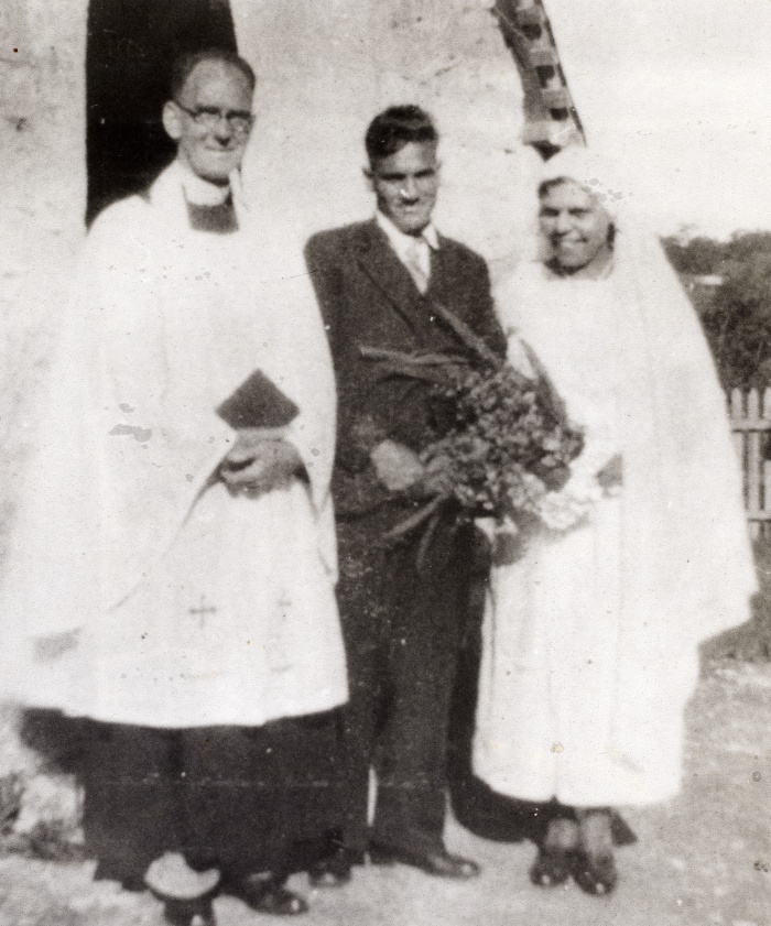 Aboriginal couple at Moore River at their wedding reverend beside them
