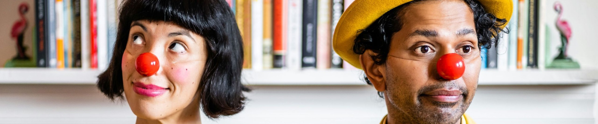 two dressed in yellow with red clown noses