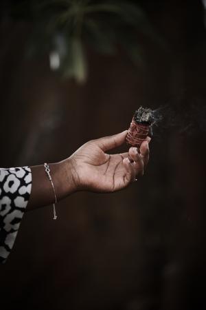 Thembi Brooking burning sage in a pre-game ritual