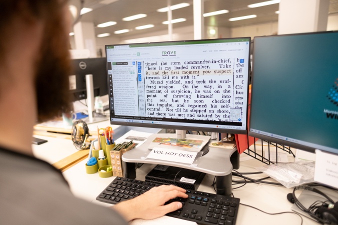 Volunteer correcting newspapers on Trove