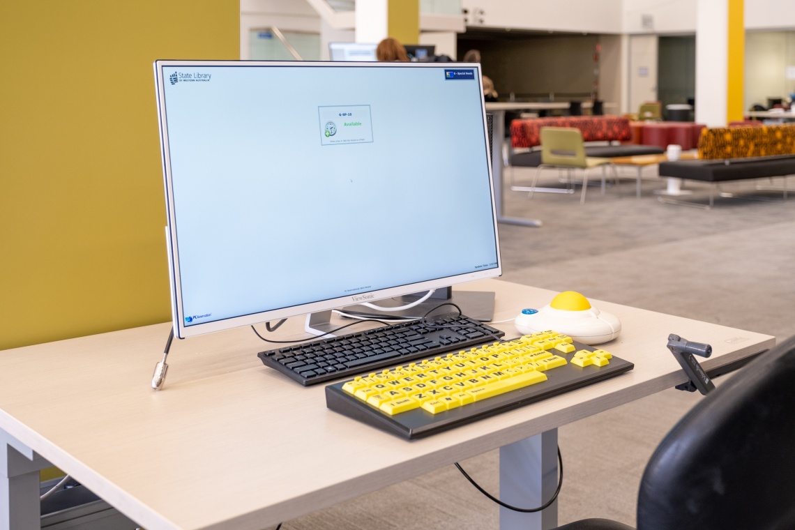 An enhanced accessibility PC showing a large keyboard and trackball mouse