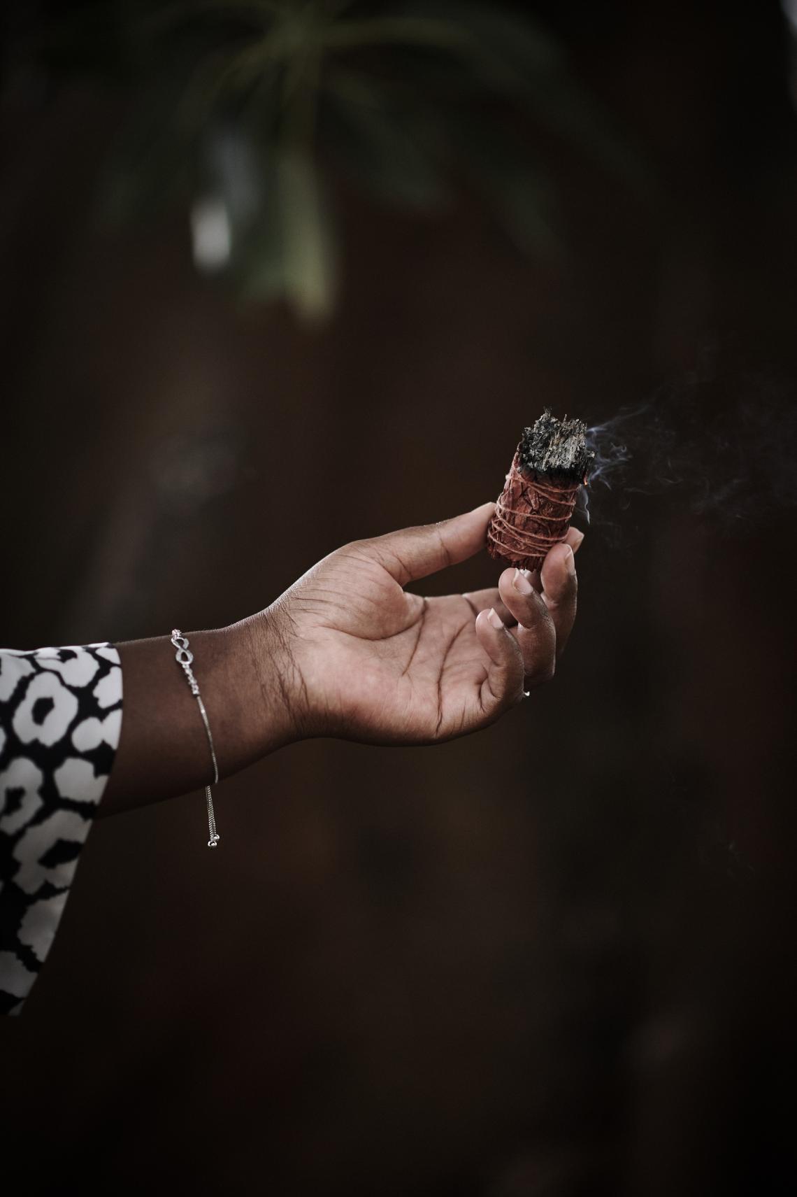 Thembi Brooking burning sage in a pre-game ritual