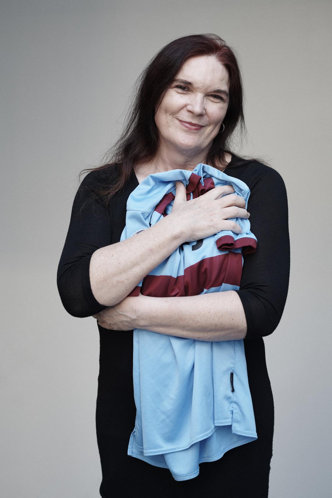 Jaime Page holding a soccer jersey