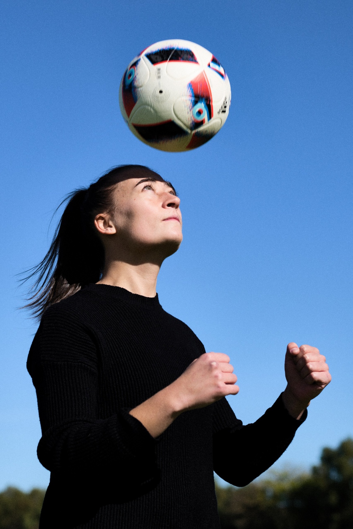 Mikayla Lyons bouncing a soccer ball on her head 