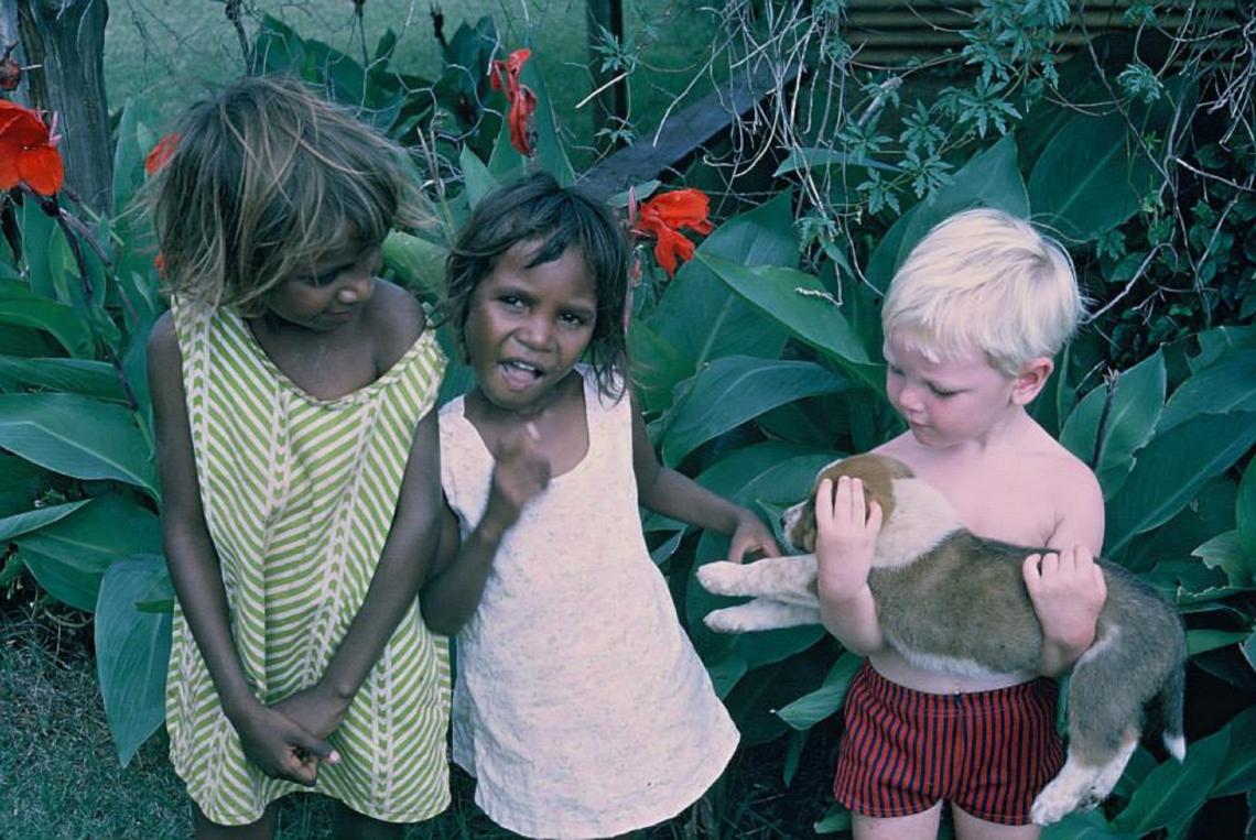 Three children standing in the garden