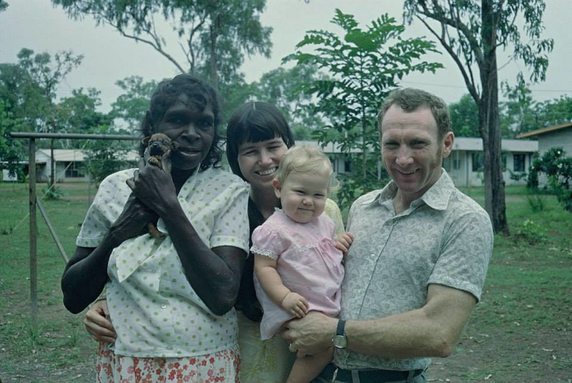 Family standing together with baby
