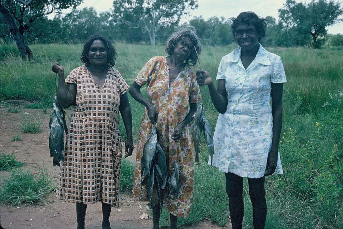 Three women holding fish