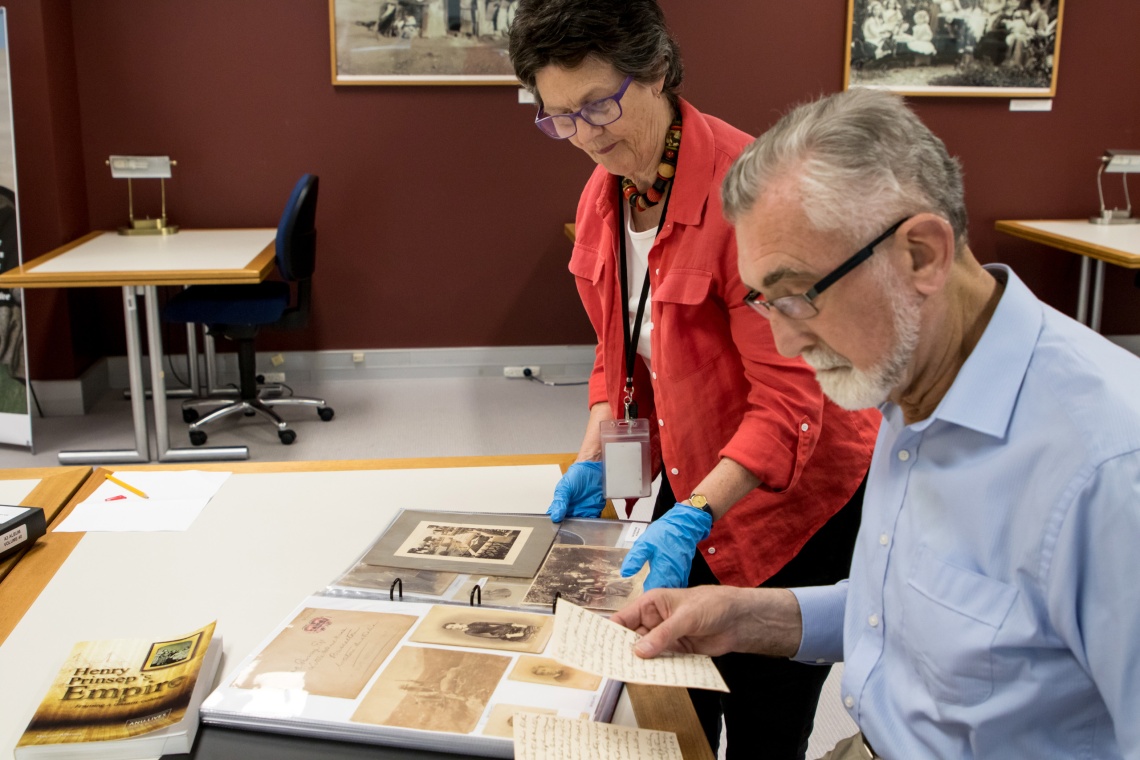 Volunteer deciphering handwriting to transcribe a collection document
