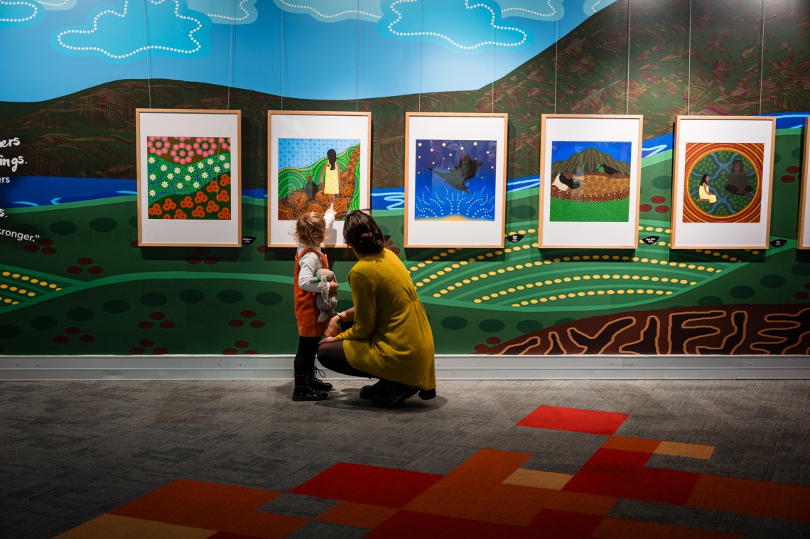 Mother and child looking at the Crow Baby Exhibition