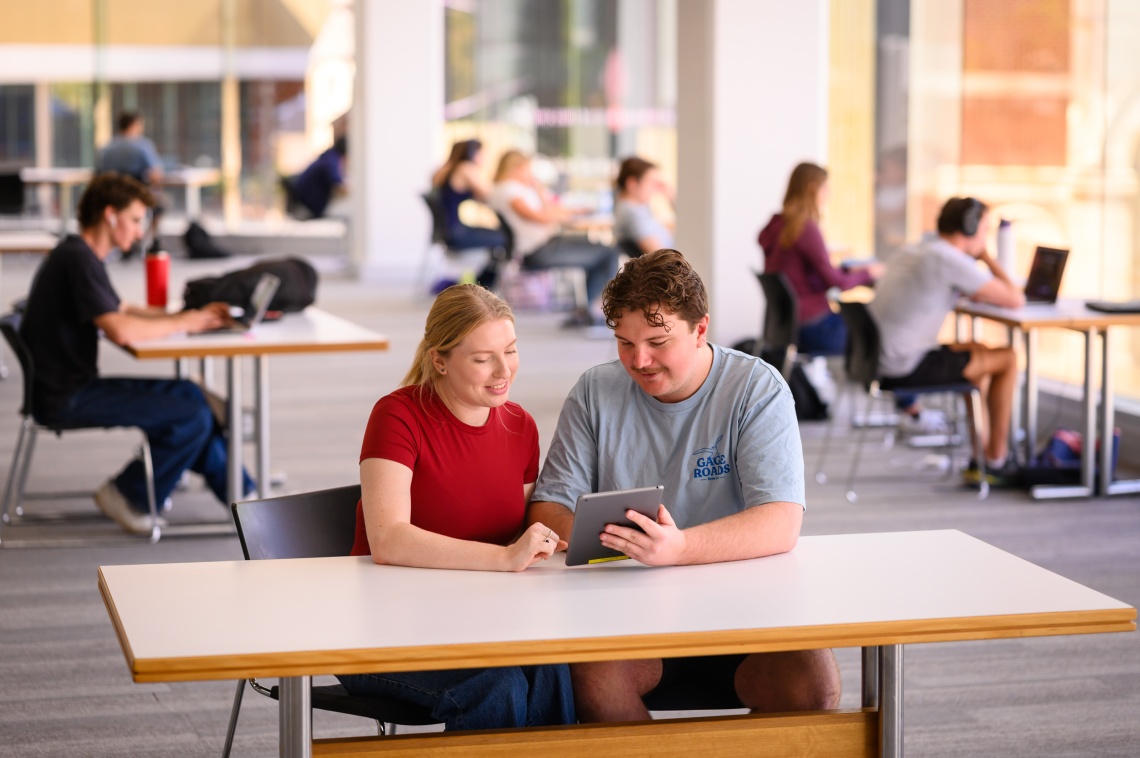 Two people looking at device